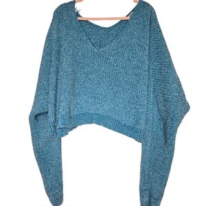 Teal-colored, cropped, oversized knit sweater with a V-neck design